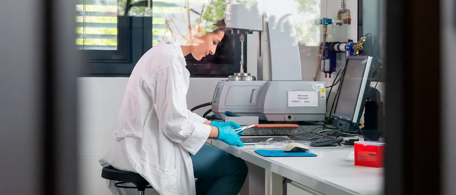 A woman works in the laboratory with material samples